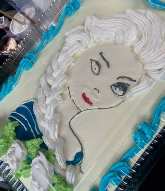 A white cake with a face drawn on it Description automatically generated with low confidence